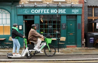 Lime Files for IPO as Shared Scooters Try to Grow Up Two Lime riders using an electric scooter and e-bike outside a coffee shop