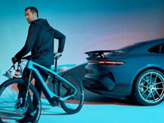 Porsche Is Shutting Down Its Performance E-Bike Division A rider on a Porsche eBike beside a Porsche Taycan Turbo GT